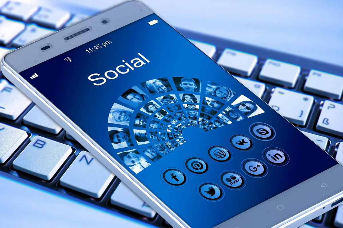 A smartphone screen displaying the Instagram app with Reels and engagement icons floating around it.