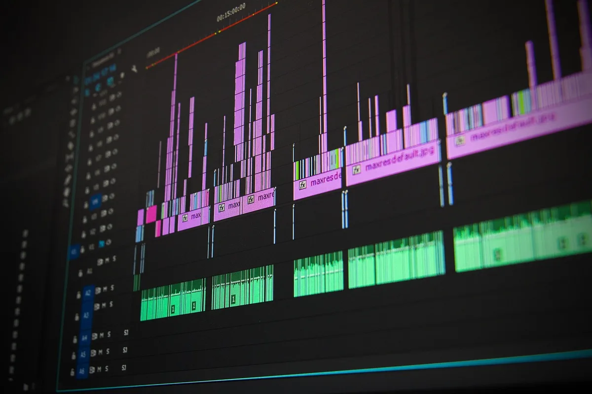 A close-up of a video editing timeline on a computer screen showing clips and audio tracks.